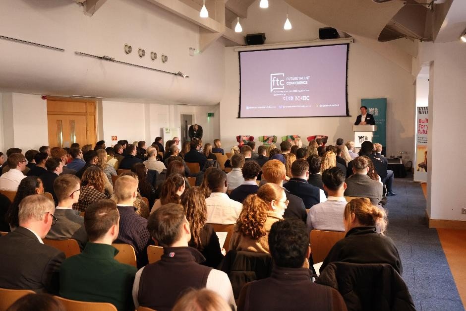 room full of people watching presentation